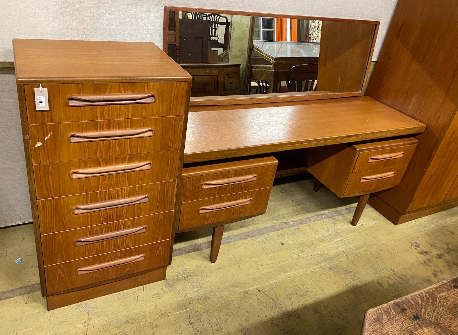 A G-plan teak three piece bedroom suite, comprising wardrobe, width 121cm, depth 58cm, height 176cm, chest of drawers and dressing table